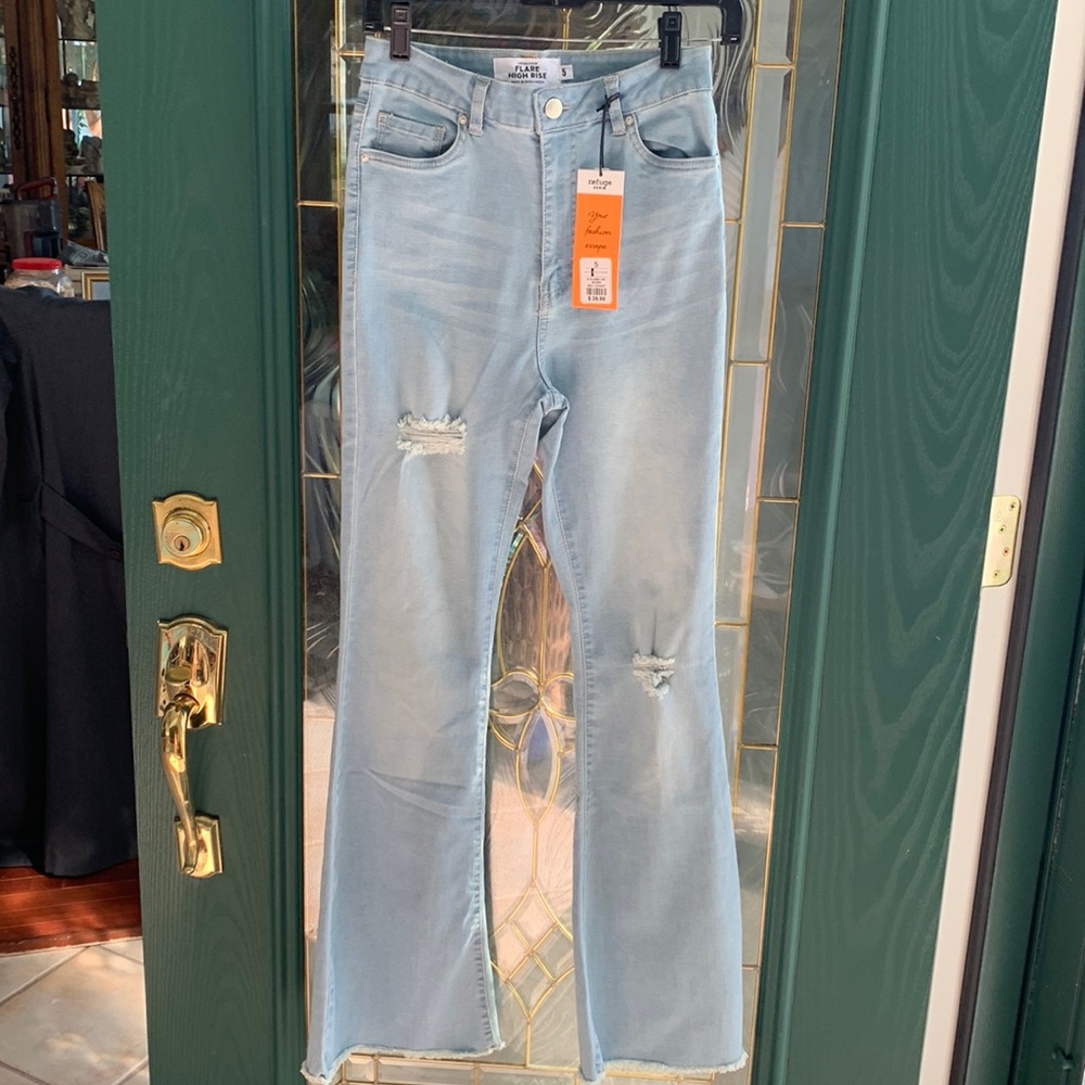 Light blue denim ripped jeans high waist flare leg. Brand new sewn above fraying